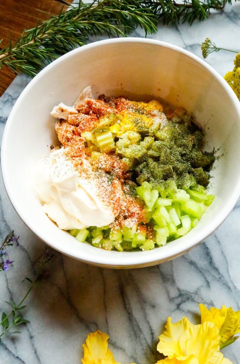 Mayonnaise, dill, paprika, garlic salt, and seasonings added to dill pickle chicken salad ingredients.
