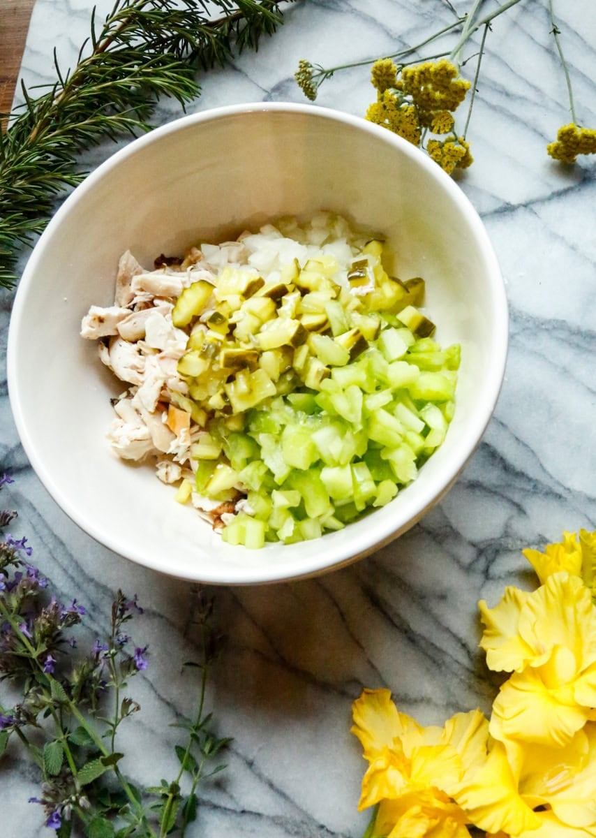 How to Make Dill Pickle Chicken Salad

Step 1: Chop the rotisserie chicken into bite-sized pieces. Dice the celery and white onion, then add everything to a large mixing bowl.