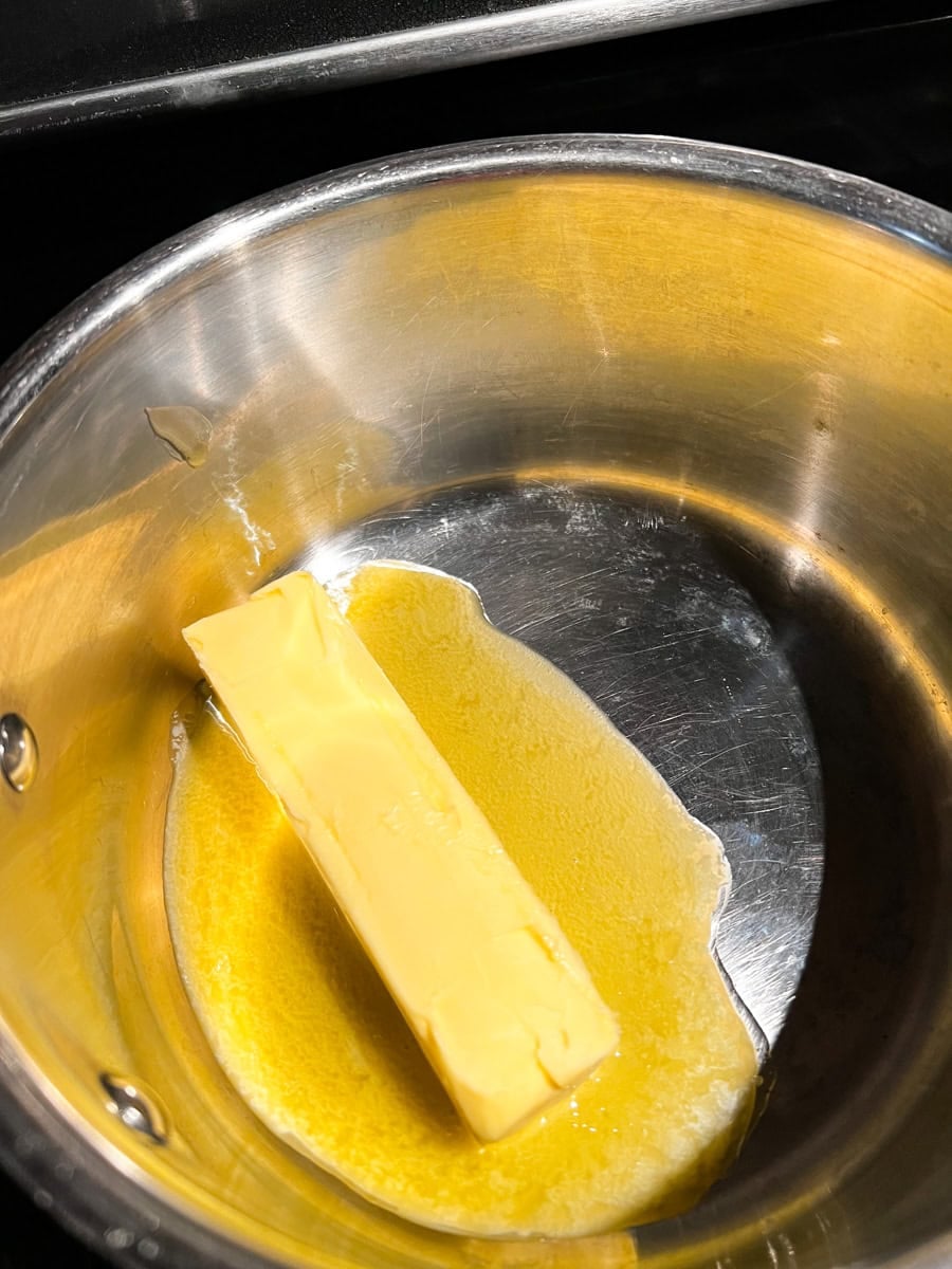 Butter melting in a saucepan over low heat to make Fourth of July Rice Krispie treats.