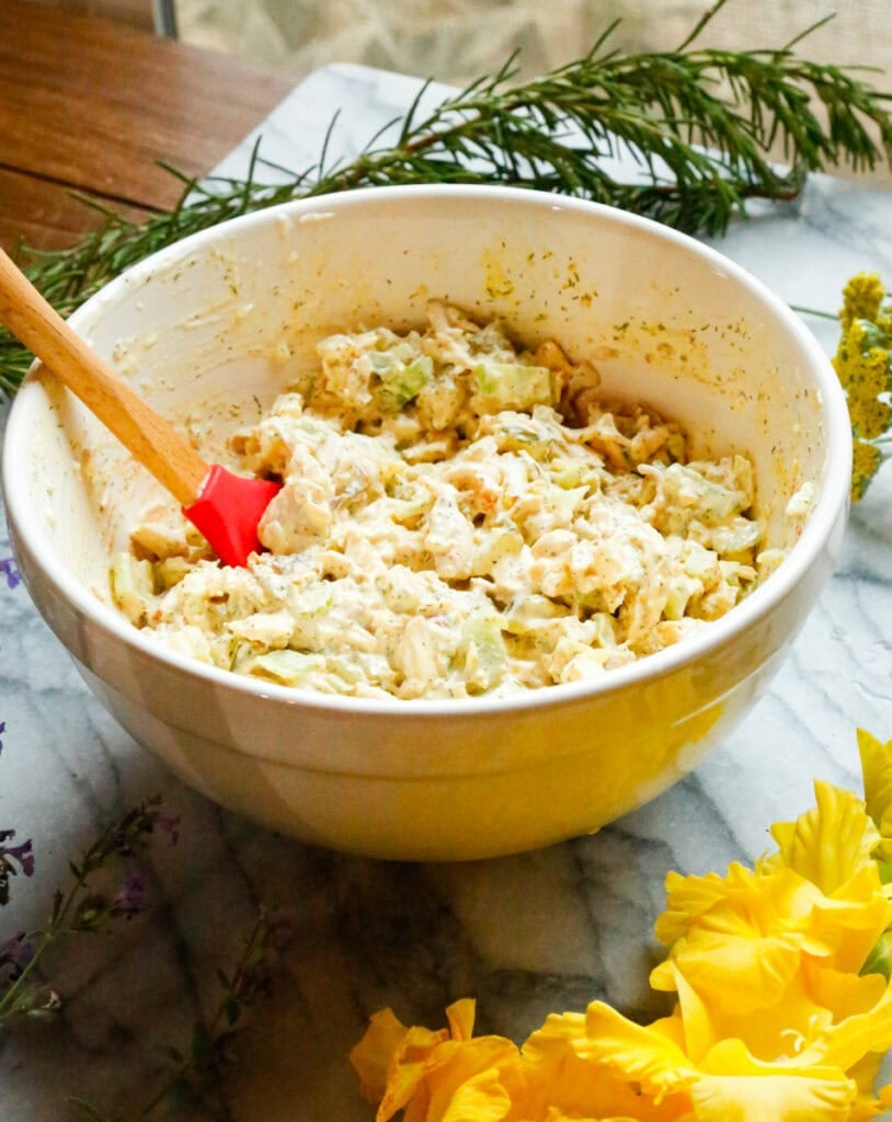 Creamy dill pickle chicken salad mixed together in a large bowl.