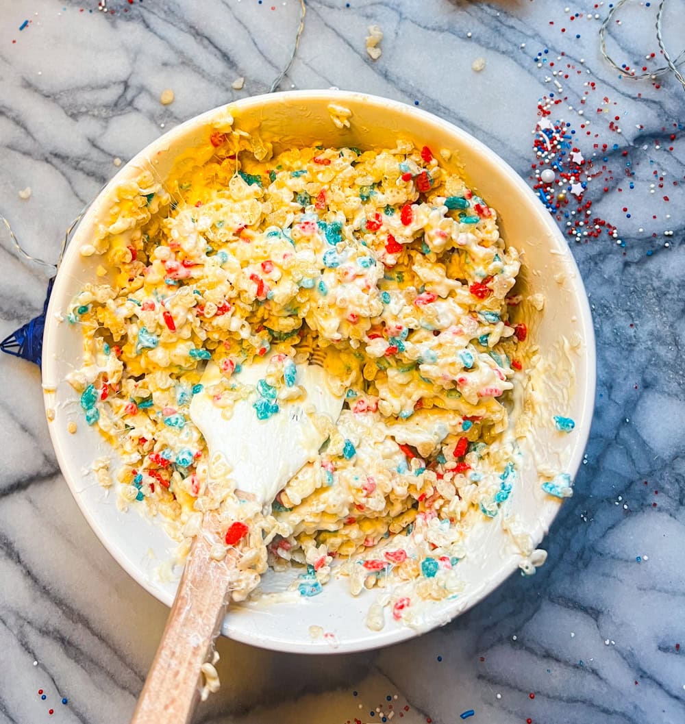 Rice Krispies cereal folded into melted marshmallows for Fourth of July Rice Krispie treats.