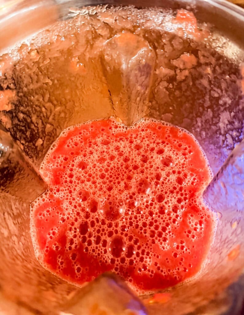 Use a blender to strain out the excess fiber from the tomatoes