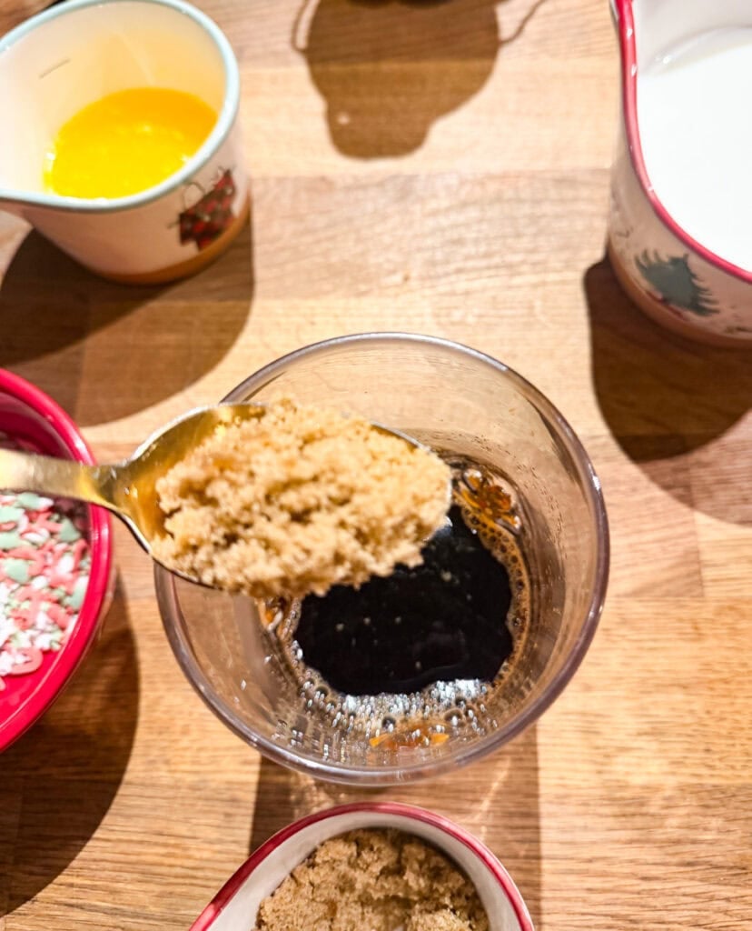 Adding a spoonful of brown sugar to freshly brewed espresso for a homemade sugar cookie latte