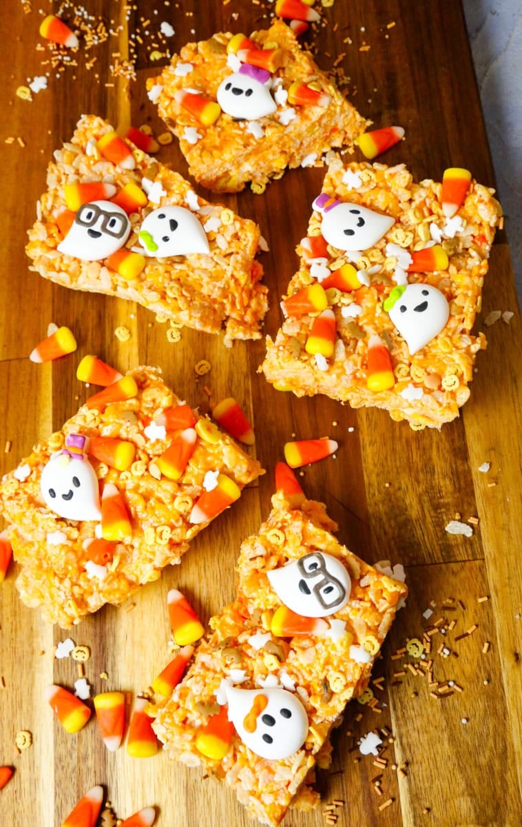 Finished candy corn Rice Krispies Treats sliced into squares and topped with Halloween sprinkles, candy corn, and ghost candies, ready to serve.